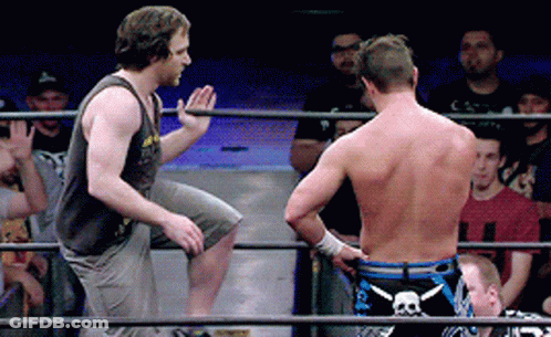 Two Men In A Wrestling Ring With One Wearing Shorts With A Skull And Crossbones On Them GIF