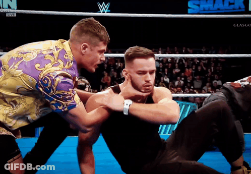 Two Men In A Wrestling Ring With The Word Smack On The Bottom Right GIF