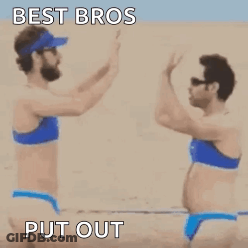 Two Women In Bikinis Holding Hands On Beach GIF