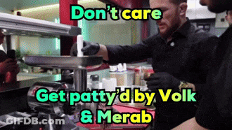Two Men In Black Gloves Working In Kitchen With Don't Care Sign GIF