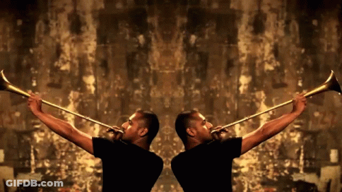 Two Men In Black Shirts Are Playing Trumpets In Front Of A Brown Wall GIF