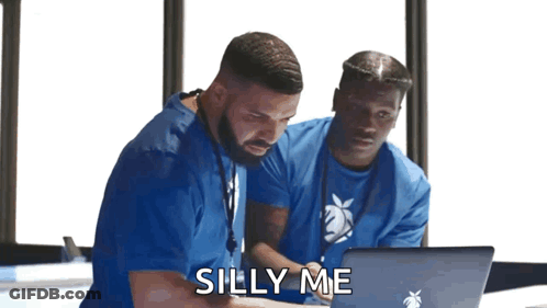 Two Men In Blue Scrubs Looking At Laptop GIF