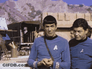 Two Men In Blue Shirts With A On Chests GIF