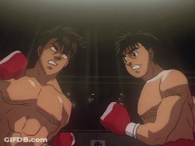 Two Men In Boxing Gloves Are Standing In A Ring GIF