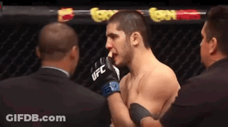 Two Men In Boxing Ring One Wearing UFC Gloves GIF