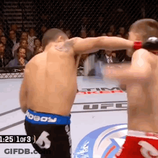 Two Men In Boxing Ring With UFC Logo GIF