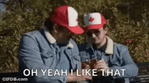 Two Men In Canadian Hats Sitting On Bench Holding Drinks GIF