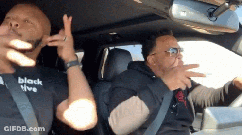Two Men In Car One Wearing Black T-Shirt Saying Black Live GIF