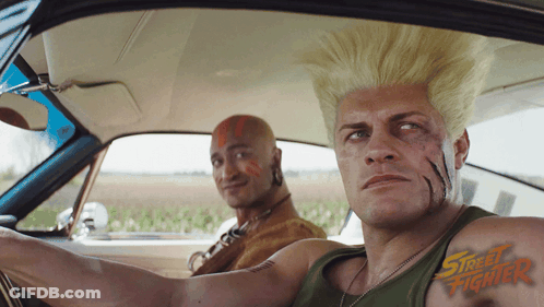 Two Men In Car With Street Fighter On Chests GIF