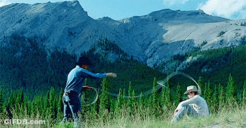 Two Men In Cowboy Hats Playing With Lasso GIF