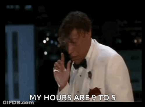 Two Men In Dark Room One Holding Microphone GIF