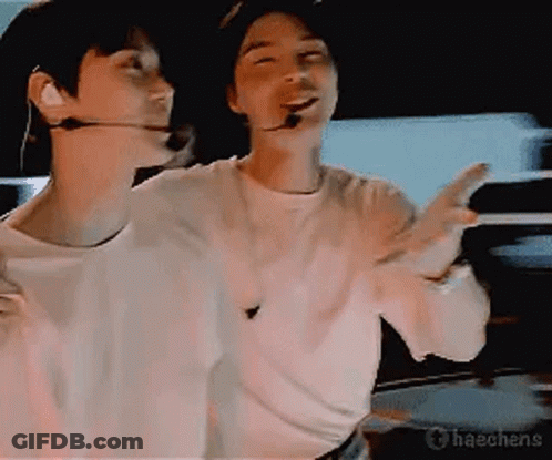 Two Men In Dark Room One With Microphone GIF