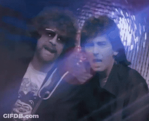Two Men In Dark Room With Purple Light GIF