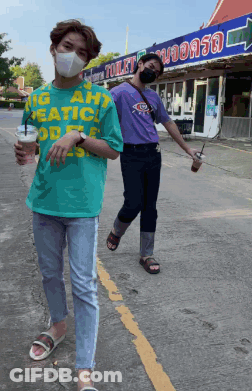 Two Men In Face Masks Walking Past Toilet Sign GIF