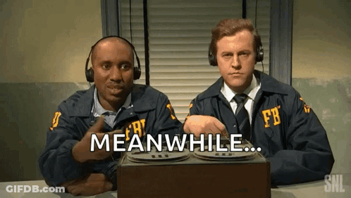 Two Men In Fbi Uniforms Are Sitting At A Table And One Of Them Says Meanwhile GIF
