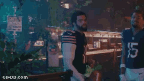 Two Men In Football Uniforms Standing GIF