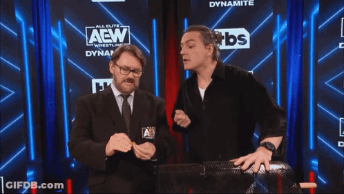 Two Men In Front Of AEW Sign GIF