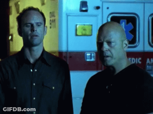 Two Men In Front Of Ambulance GIF