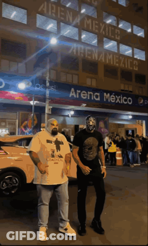 Two Men In Front Of Arena Mexico GIF