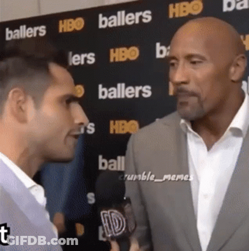 Two Men In Front Of Baller Wall GIF