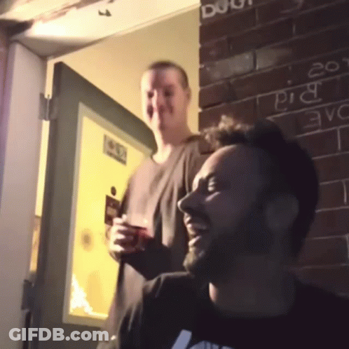 Two Men In Front Of Brick Wall Saying Pig GIF