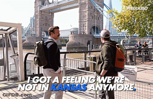 Two Men In Front Of Bridge Saying I Got A Feeling We're Not In Kansas Anymore GIF