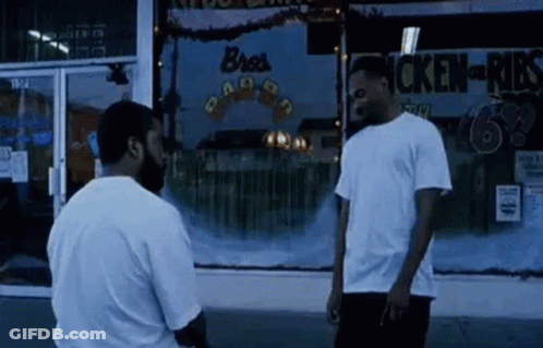 Two Men In Front Of Chicken Shop GIF