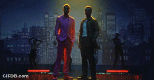 Two Men In Front Of City Skyline GIF