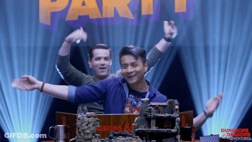 Two Men In Front Of Dungeons And Dragons Adventures Sign GIF