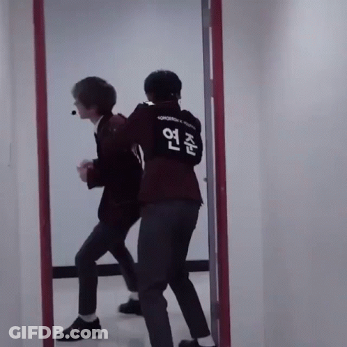 Two Men In Front Of Mirror One Wearing Tomorrow Shirt GIF