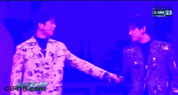 Two Men In Front Of Purple Background Saying GMM 25 GIF