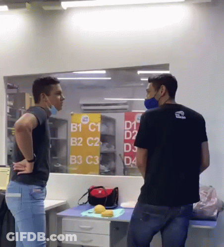 Two Men In Front Of Sign B1 C1 B2 C2 B3 C3 D4 GIF