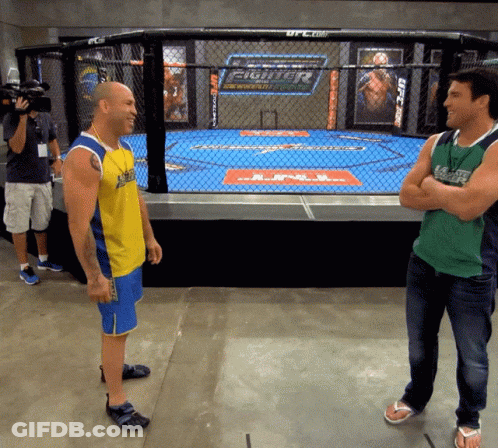 Two Men In Front Of UFC Cage GIF