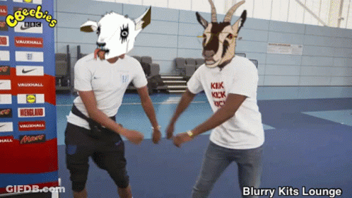 Two Men In Goat Masks Dancing In Front Of Cheebies BBC Banner GIF