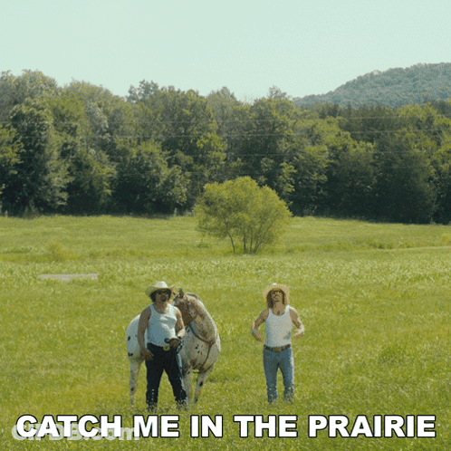 Two Men In Grassy Field Catch Me In The Prairie GIF