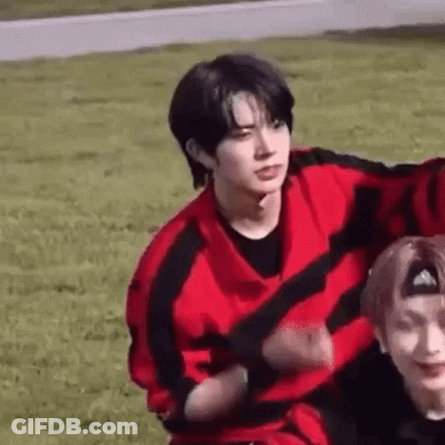 Two Men In Grassy Field Man In Red And Black Sweater GIF