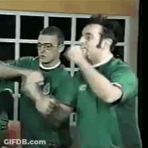 Two Men In Green Shirts One With Number 1 GIF