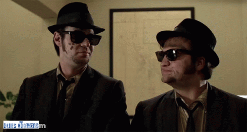 Two Men In Hats And Sunglasses Blues Brothers Sign GIF