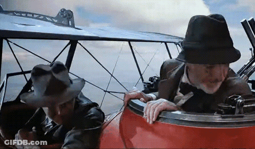 Two Men In Hats Sitting In Plane GIF