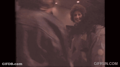 Two Men In Headphones High Fiving While Dancing GIF