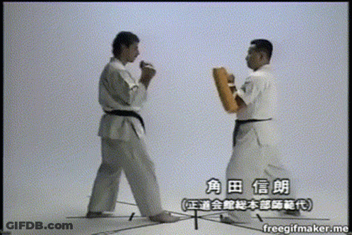 Two Men In Karate Uniforms Are Standing Next To Each Other And Their Names Are Written In Chinese GIF