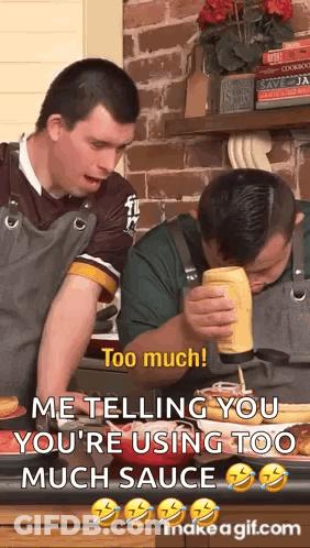 Two Men In Kitchen One Pouring Mustard On Food GIF
