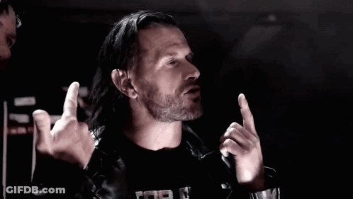 Two Men In Leather Jackets Are Giving The Middle Finger In A Dark Room GIF