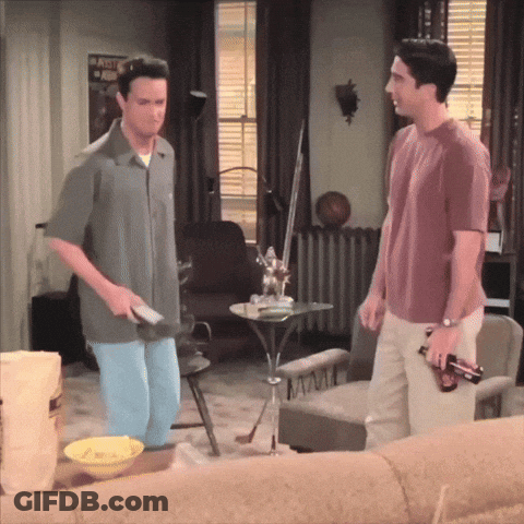 Two Men In Living Room With Army Poster GIF