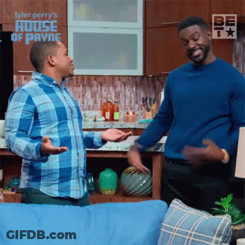 Two Men In Living Room With Tyler Perry's House Of Payne Background GIF