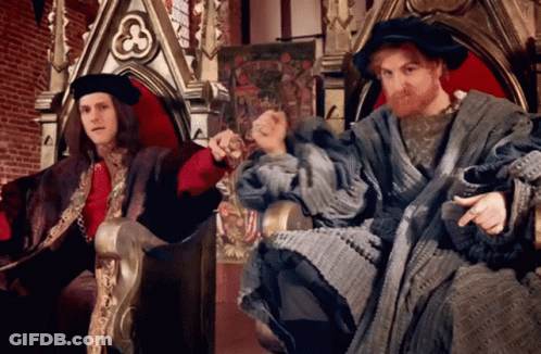 Two Men In Medieval Costumes On A Throne One With Beard GIF