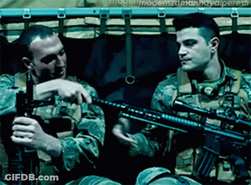 Two Men In Military Uniforms Are Holding Guns And One Has The Word Modern On His Back GIF