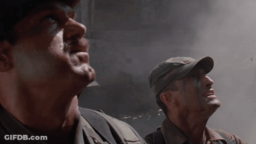 Two Men In Military Uniforms Are Looking Up At The Sky GIF