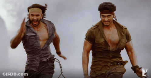 Two Men In Military Uniforms Are Running And One Has A Headband On His Head GIF
