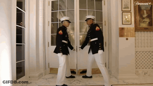 Two Men In Military Uniforms By Paramount Door GIF